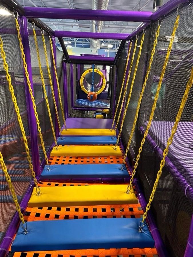 Chain bridge obstacle course with colorful steps at Sheffield Village